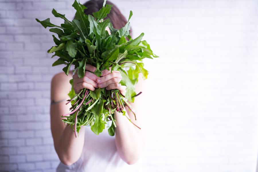woman holding leafy greens